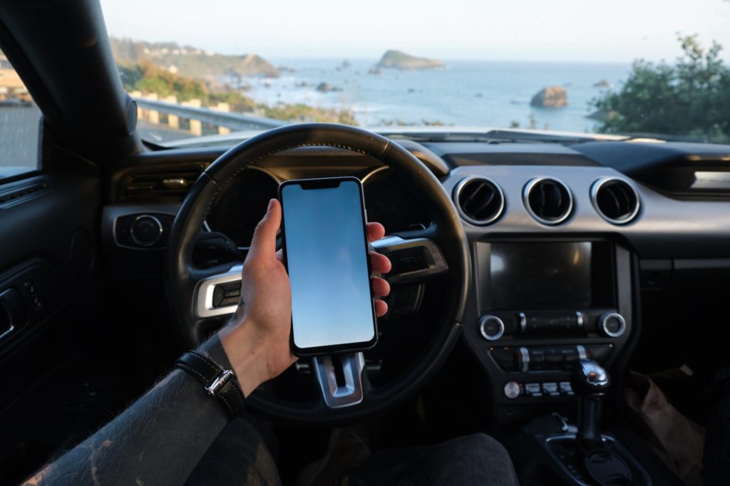 crop traveler using smartphone in car